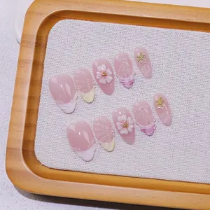 Handmade press-on nails with 3D floral and seashell patterns in pink gradient