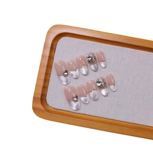 Handmade French cat-eye press-on nails with silver bows and heart-shaped rhinestones