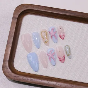 Handmade almond-shaped ocean theme press-on nails with 3D starfish pearls and water droplets