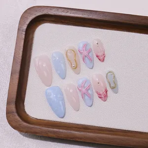 Ocean-themed handmade almond nails with 3D starfish, pearls, and shell texture