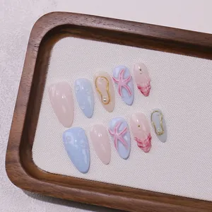 Handmade almond press-on nails with 3D ocean starfish, pearls and light blue shell details