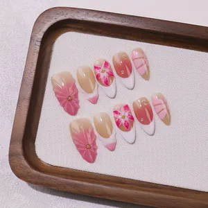 Handmade pink almond press-on nails with 3D floral carving and French leopard gradient
