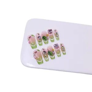 Handmade forest green cat eye press-on nails with 3D crystals and bow charms