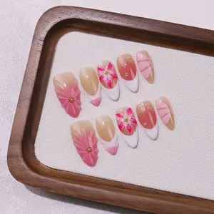 Handmade almond press-on nails with pink floral relief, French tips and pearls