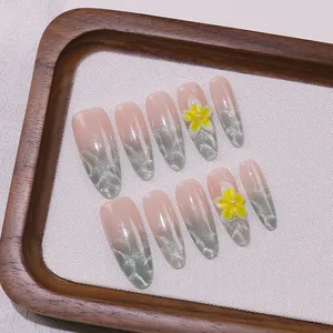 Uñas postizas de olas marinas efecto ojo de gato con flor amarilla 3D
