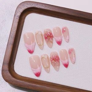 Pink French ombre press-on nails with 3D flower carvings and delicate gold chain accents