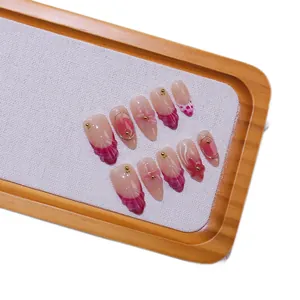 Handmade almond press-on nails with 3D flower carvings and pink gradient design