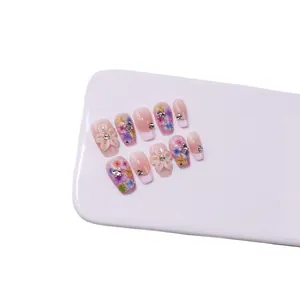 Handmade press-on nails with 3D floral carving and gradient purple finish on long coffin shape