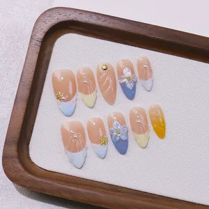 Handmade almond press-on nails with 3D floral, shell motifs and pearl accents