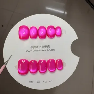 Short square pink cat-eye press-on nails set with metallic glitter finish on card
