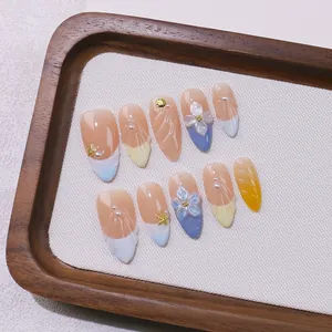 Handmade almond press-on nails with 3D floral carving, sea stars, and pearl charms