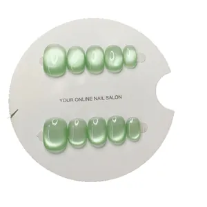 Short square light green cat eye press-on nails set on white display card