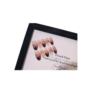 Handmade burgundy French cat-eye press-on nails with 3D bows and polka dot accents
