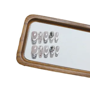 Handmade cat-eye press-on nails in grey and silver with rhinestones and glitter