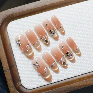 Handmade almond cat-eye press-on nails in nude gradient with bows and pearls