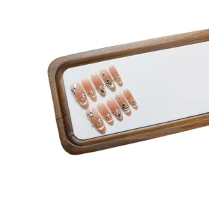 Handmade gradient nude pink cat-eye press-on nails with butterfly and pearl accents