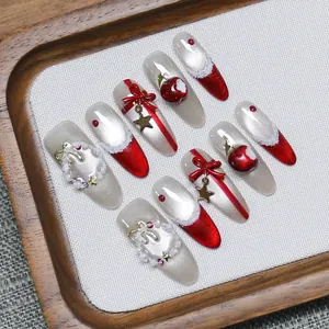 Handmade Christmas press-on nails with red bows, pearls, and festive apple charms