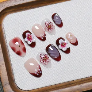 Handmade press-on nails with 3D floral art in elegant burgundy and nude pink shades
