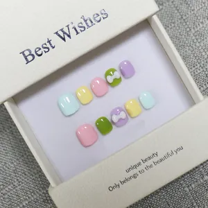 Handmade macaron press-on toenails with white 3D bows in an elegant gift box