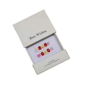 Handmade press-on nails for kids featuring red checkered pattern and cute 3D cloud charms