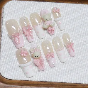 Handmade press-on nails with 3D pink bows, pearls, and cute bear charms in pink ballet style