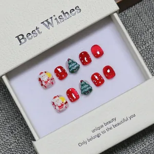 Handmade Christmas press-on nails for kids with 3D Santa and tree designs in gift box