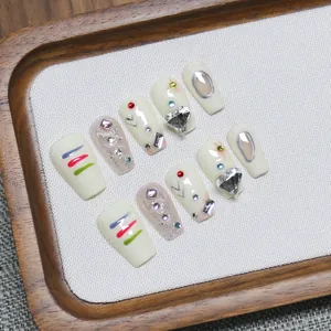 Handmade Y2K press-on nails set with silver glitter and 3D heart charms on wood tray