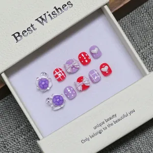Handmade press-on nails for kids with cute purple 3D turtle and colorful bow designs