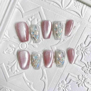 Pink cat-eye press-on nails with silver glitter butterfly and coffin trapezoid shape