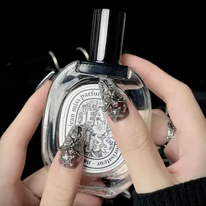 Gothic dark style press-on nails with silver metal crosses and angel wings details