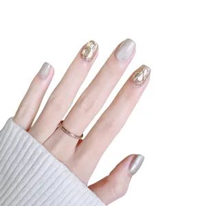 Handmade champagne cat-eye press-on nails with sparkling rhinestones and glitter finish
