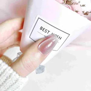 Pink cat eye press-on nails with luxury crystal accents and a shimmering finish