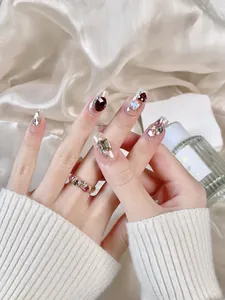Detailed view of handmade press-on nails with luxury crystals, pearls and glitter design