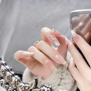 Handmade cat-eye press-on nails in nude pink gradient with chain and diamond accents
