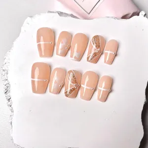 Handmade almond press-on nails in nude pink with pearl accents and floral patterns
