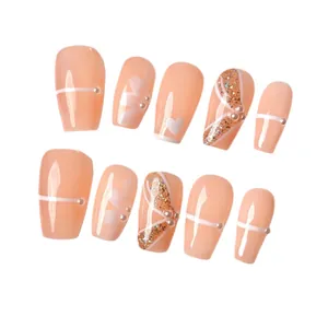 Handmade press-on nails with nude pink base, pearls, hand-painted flowers and gold glitter