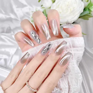 Sparkling silver cat-eye press-on nails with glitter and rhinestones in long trapezoid shape