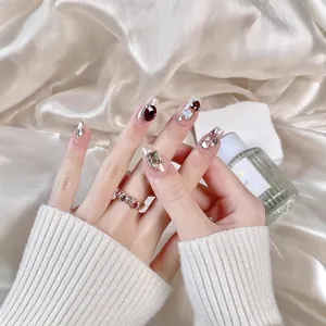 Sparkling handmade press-on nails with luxury red heart gemstones and aurora butterfly accents