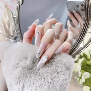 Sparkling pink almond press-on nails with silver cat-eye glitter and 3D gemstone accents