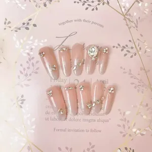 Handmade almond press-on nails in nude pink cat eye finish with sparkling crystals