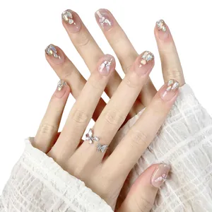 Handmade nude pink press-on nails with iridescent shell flakes and butterfly designs