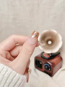 Detailed close-up of brown gradient press-on nails with silver glitter accents