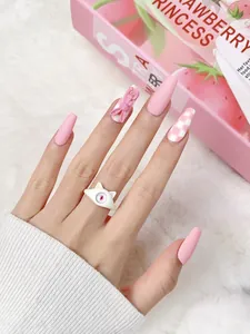 Detail of pink matte press-on nails with 3D bunny accents and checkered patterns