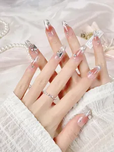 Macro detail of handmade press-on nails with luxury rhinestones and silver glitter