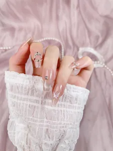 Close-up of handmade press-on nails with 3D crystal butterfly and silver glitter details