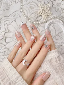 Detail of luxury French white swan cat eye press-on nails with shiny rhinestones