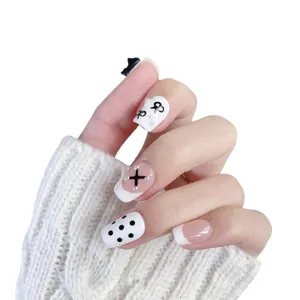 Handmade press-on nails with French bow designs and pearl accents for a stylish look