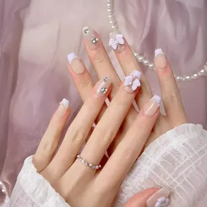 Handmade French press-on nails with white bows, pearls, and silver glitter finish
