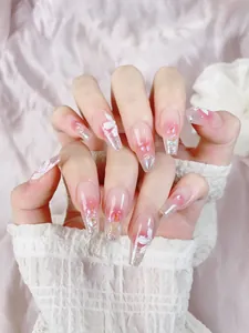 Close-up of long coffin press-on nails with 3D floral accents and pearl decorations