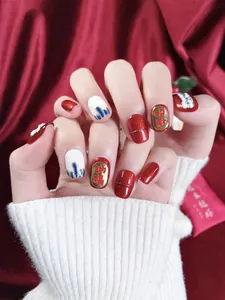 Detailed view of handmade festive red press-on nails with lucky lion and calligraphy art